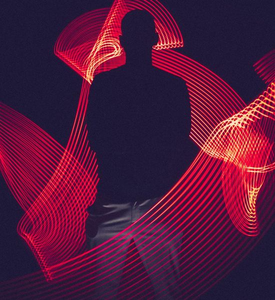 Abstract image of light flowing through a human silhouette, symbolizing energy.